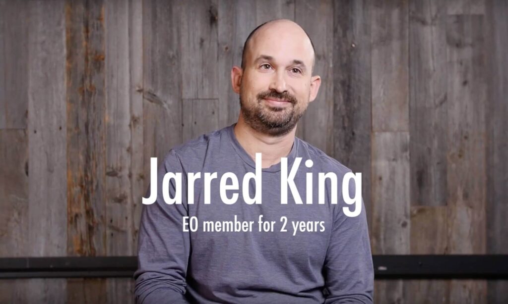 An EO member looking at the camera with the words "Jarred King, EO member for 2 years" on the screen