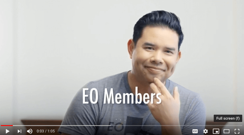 An EO member looking at the camera with the words "EO members" on the screen