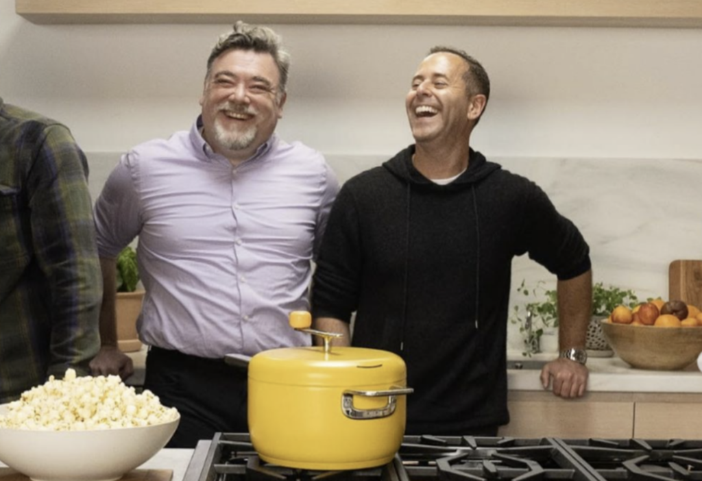 Tal Moore stands with other entrepreneurs in a kitchen laughing